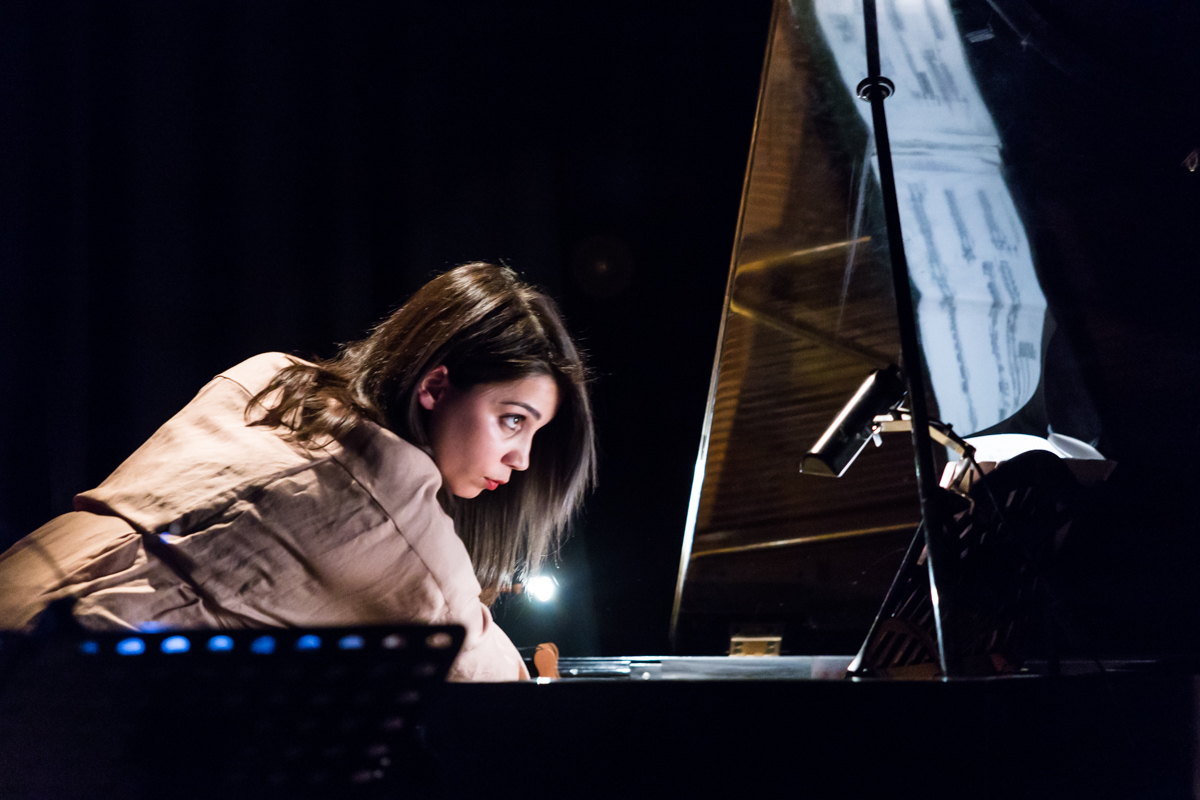 Image of pianist on top of open piano